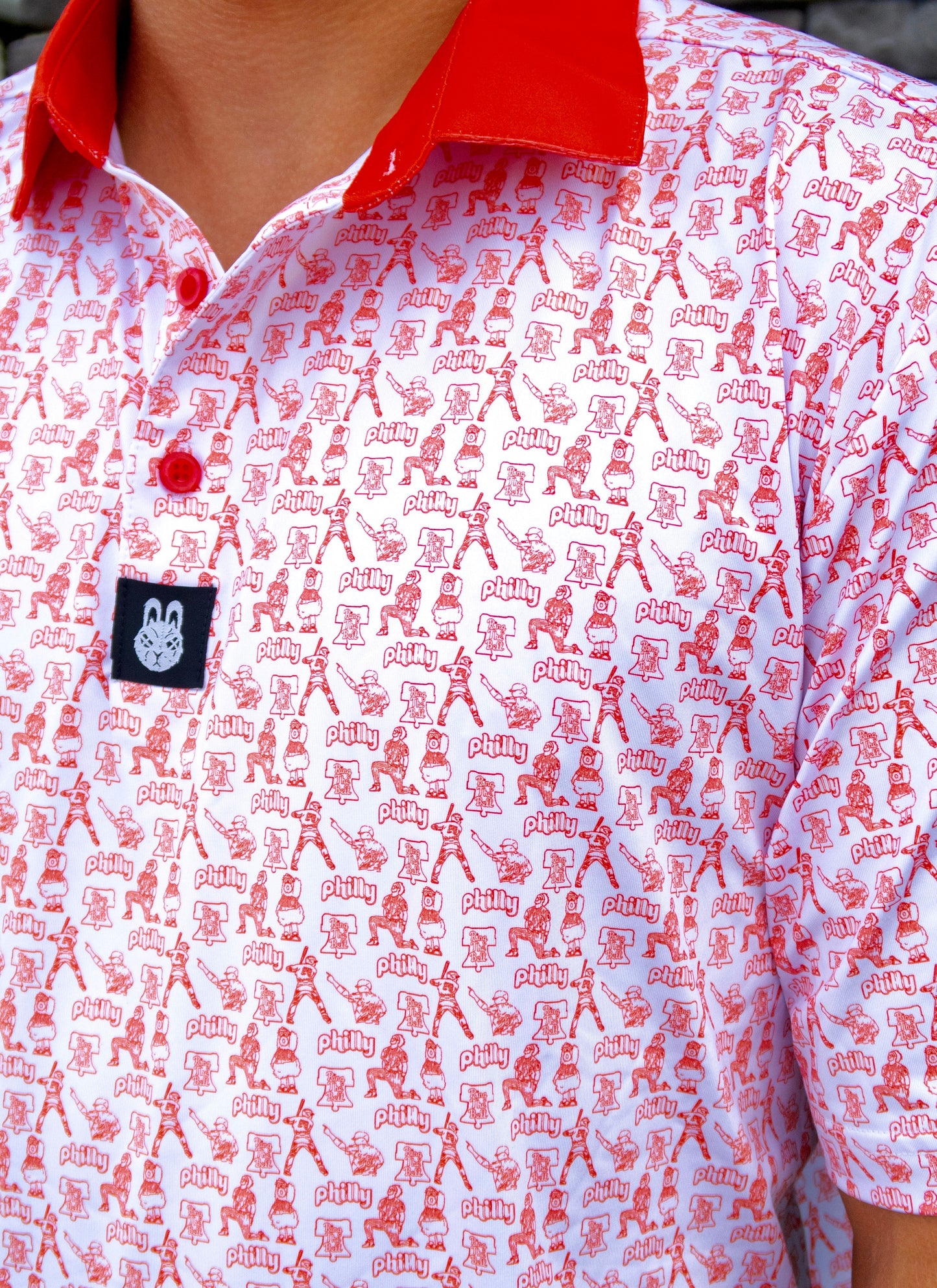 Close-up of The South Philly Sandlot golf polo fabric, buttons, and stitching with Philadelphia baseball-inspired red and white design details