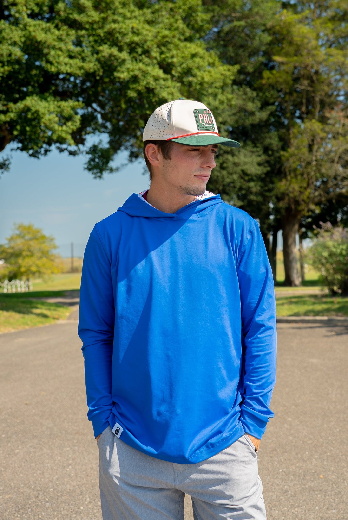 Front view of men’s royal blue golf hoodie with lightweight performance fabric, front-facing fit, and subtle athletic style—perfect for course or casual wear.