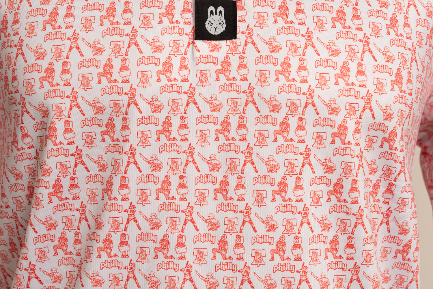 Close-up front view of The South Philly Sandlot golf polo highlighting red and white Philadelphia baseball-inspired design and premium performance fabric
