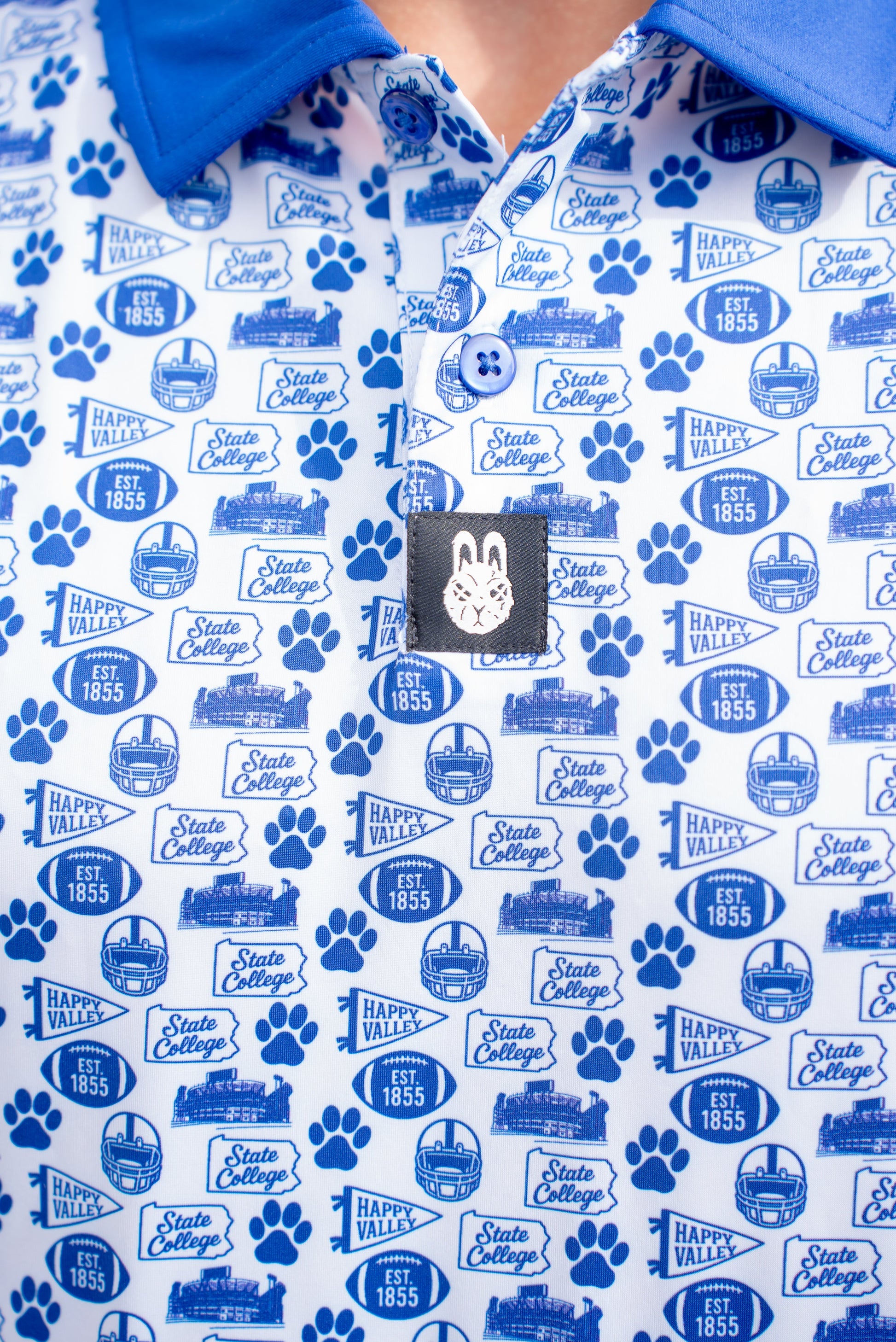 Close-up of the blue and white Happy Valley game day golf polo showing fabric texture and detailed stitching