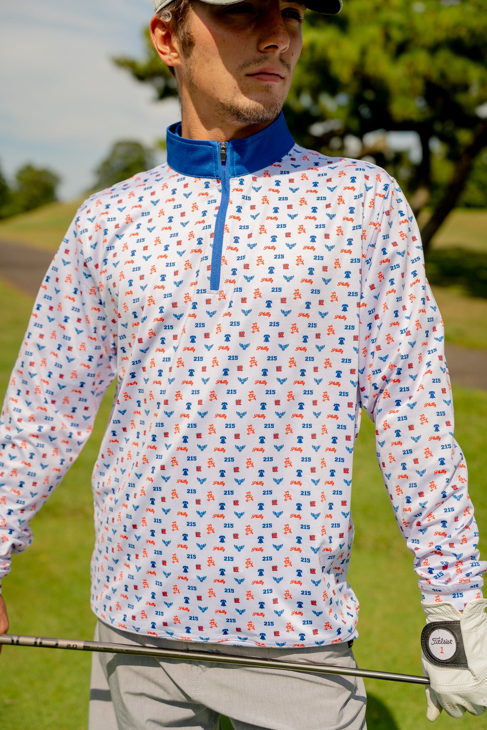 Front view of The Phrenetic Zip men’s quarter zip in Philly-inspired colors, featuring lightweight performance fabric and bold streetwear energy.