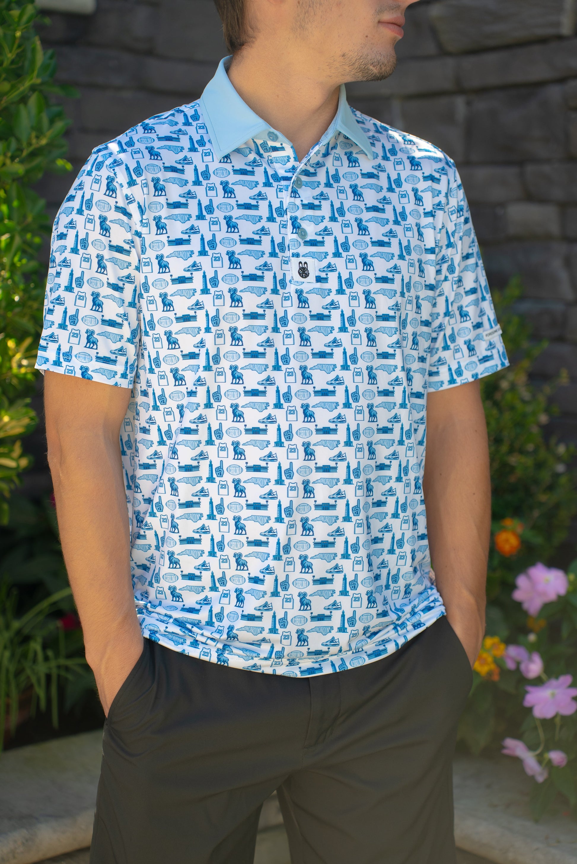 Front view of the Chapel Hill Hangtime men’s golf polo, UNC-inspired design with blue tones and performance fit for golfers and fans.